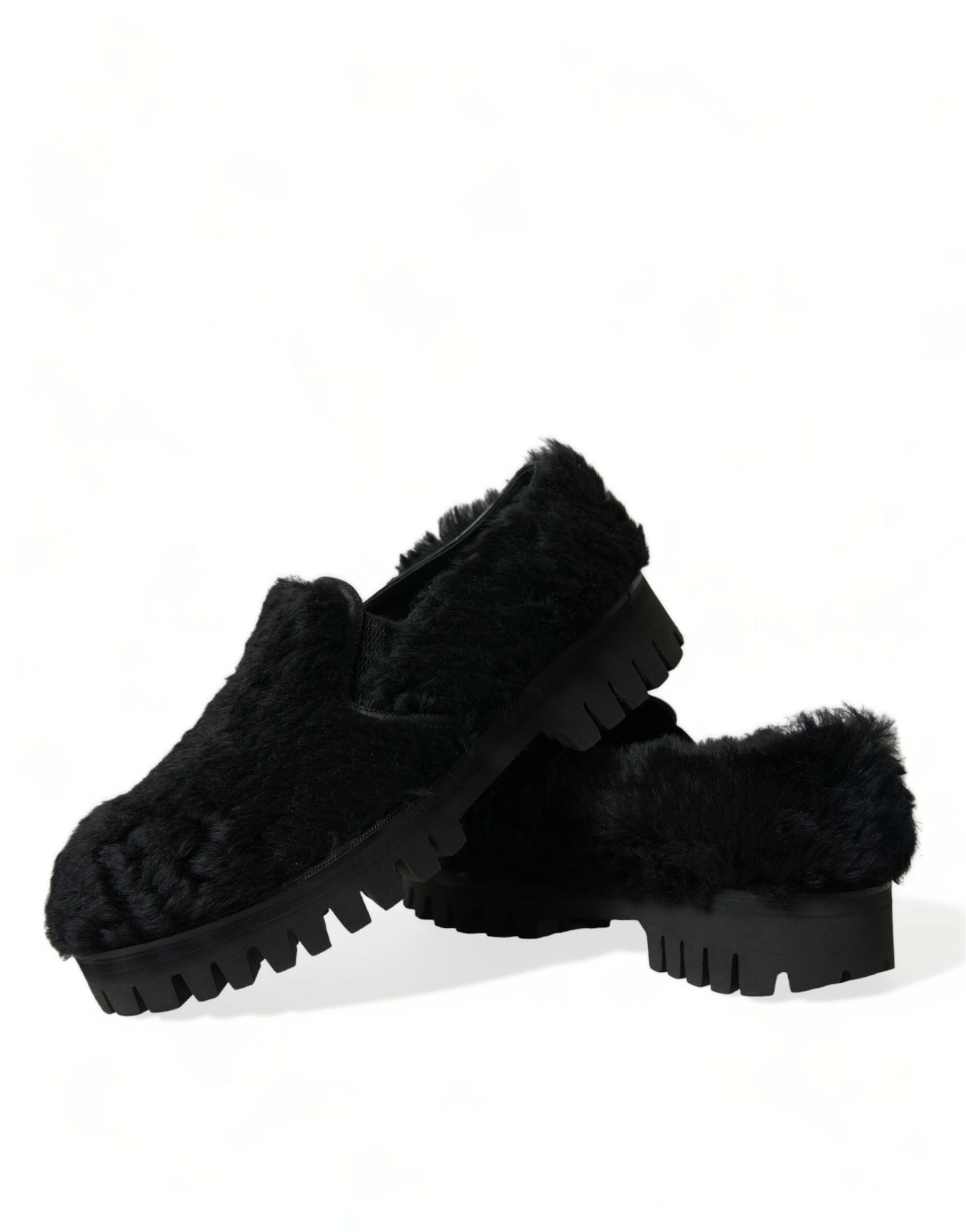 Pair of black fuzzy slippers with a patterned sole