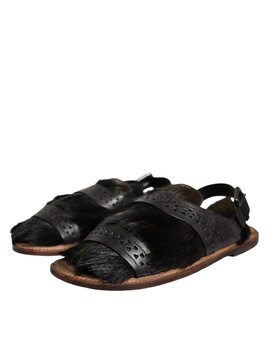 Pair of black sandals with brown straps
