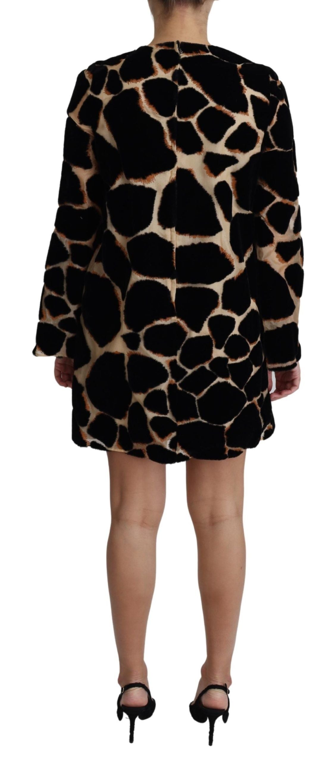 A black giraffe print mini dress with short sleeves and a shift style