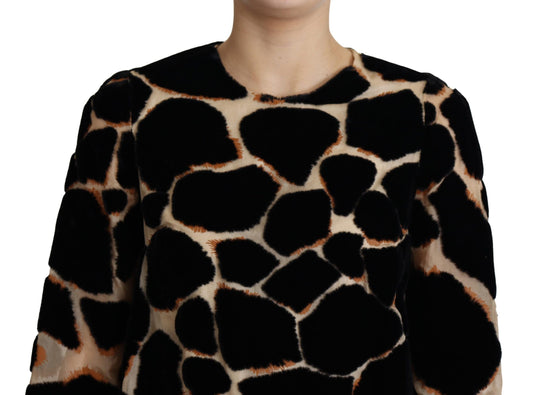 A black giraffe print shift mini dress with a round neckline and short sleeves