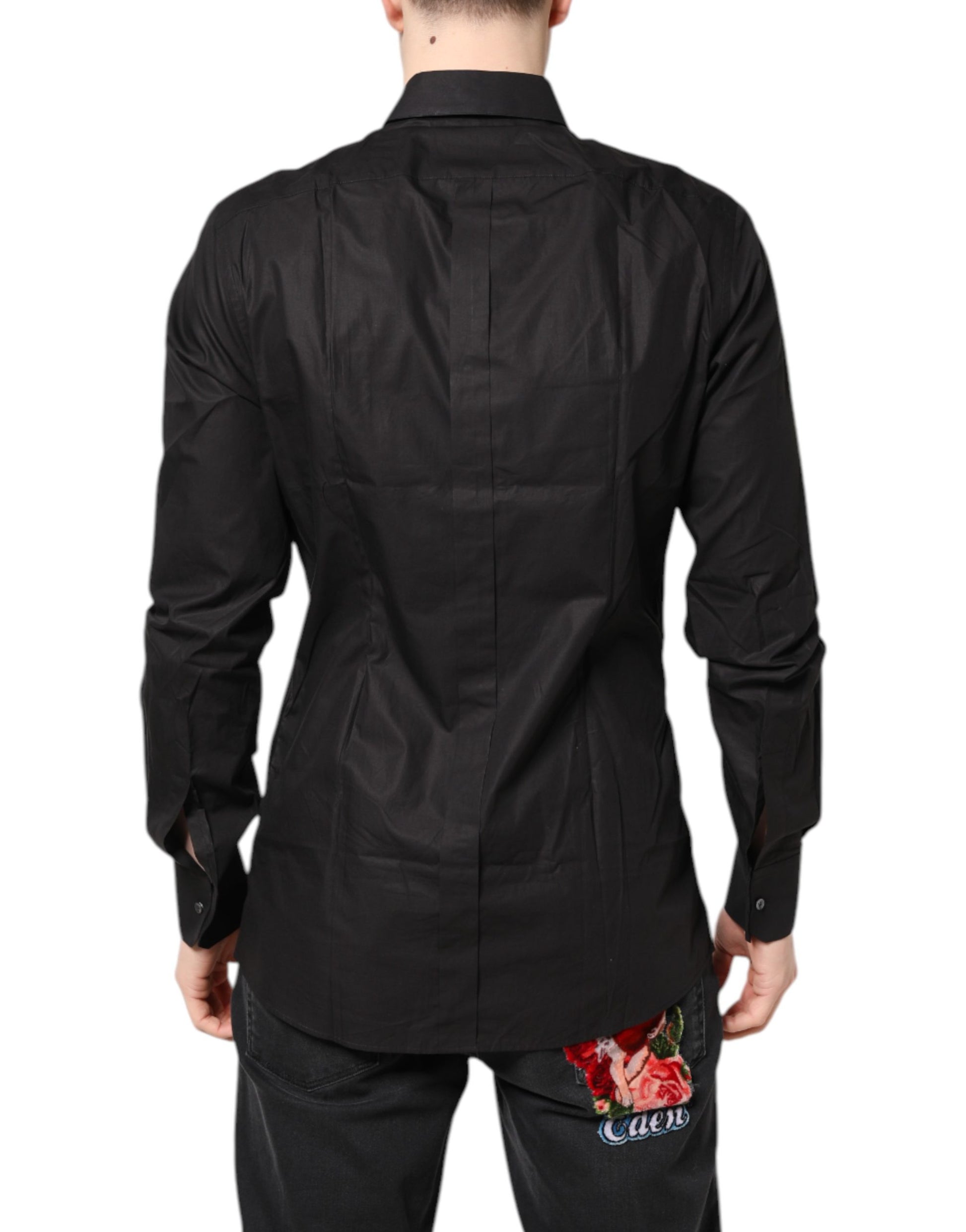 A black collared dress shirt with gold accents and a floral embroidery on the back