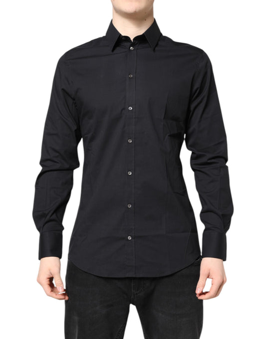 A black dress shirt with long sleeves and gold accents. It is designed by Dolce & Gabbana and made of cotton