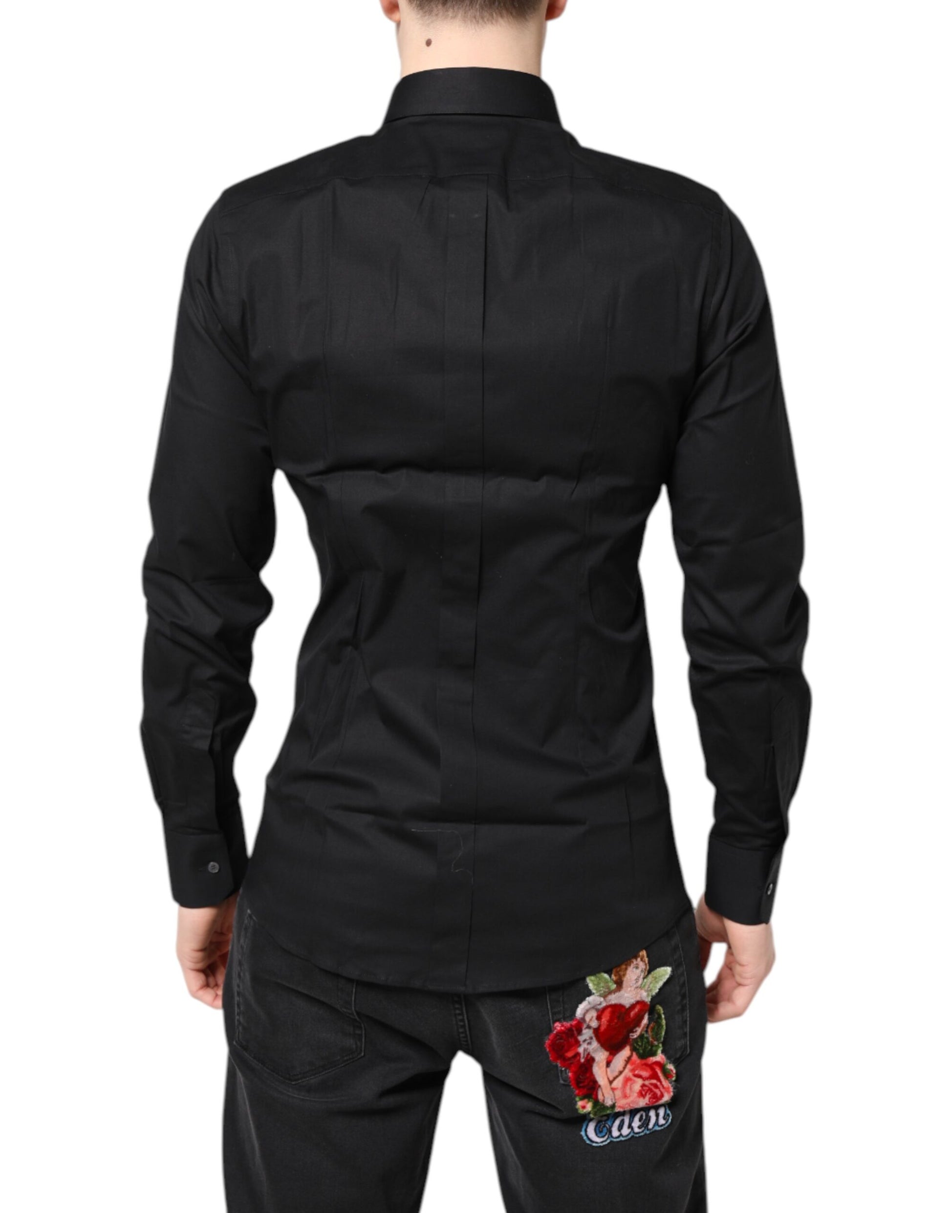 A black dress shirt with gold accents and a floral embroidery on the back