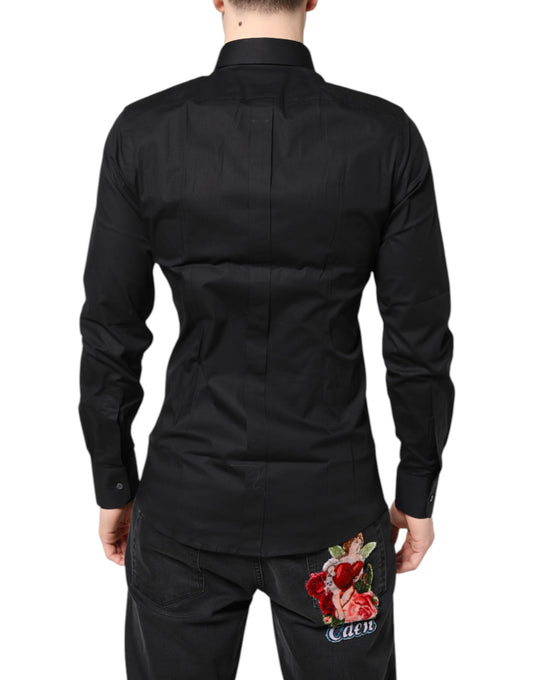 A black dress shirt with gold accents and a floral embroidery on the back