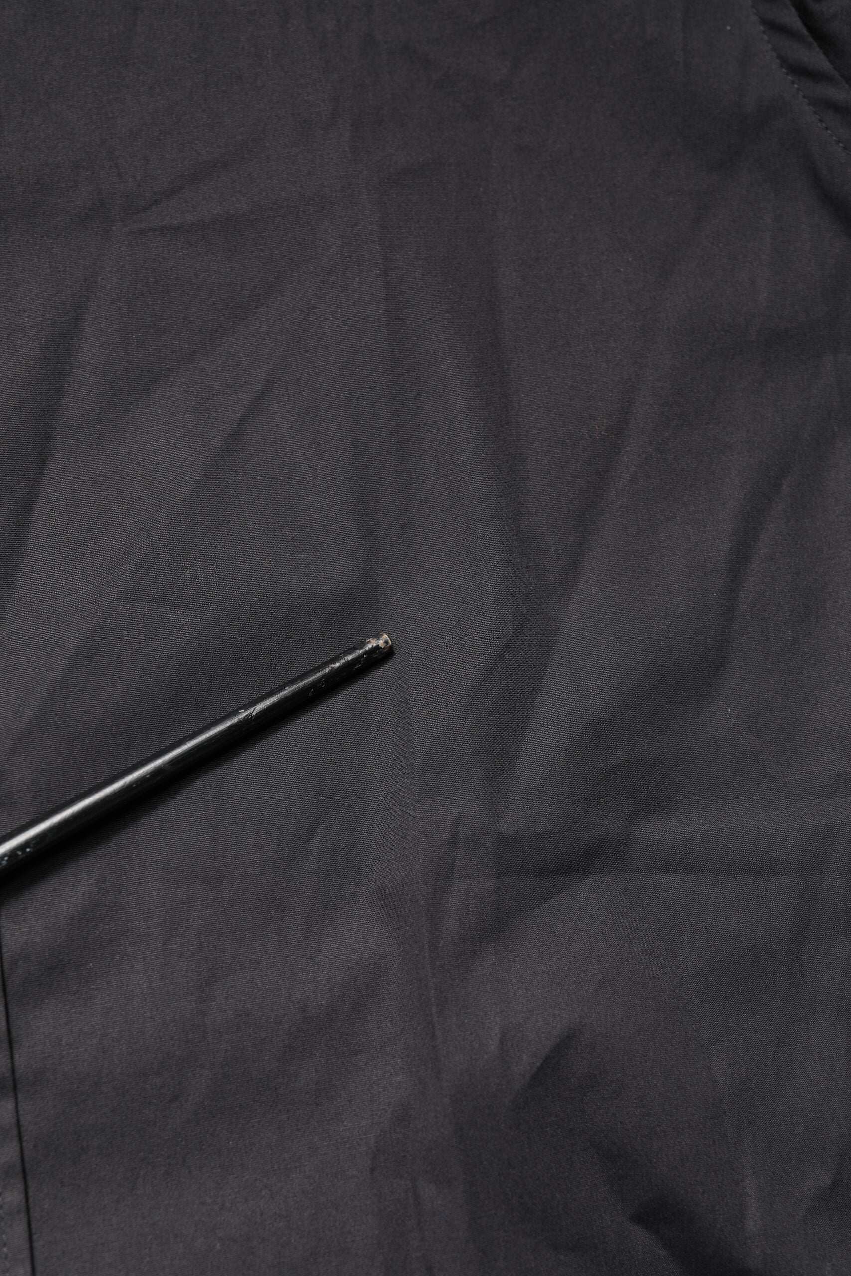 A black cotton dress shirt with gold accents, long sleeves, and a collar