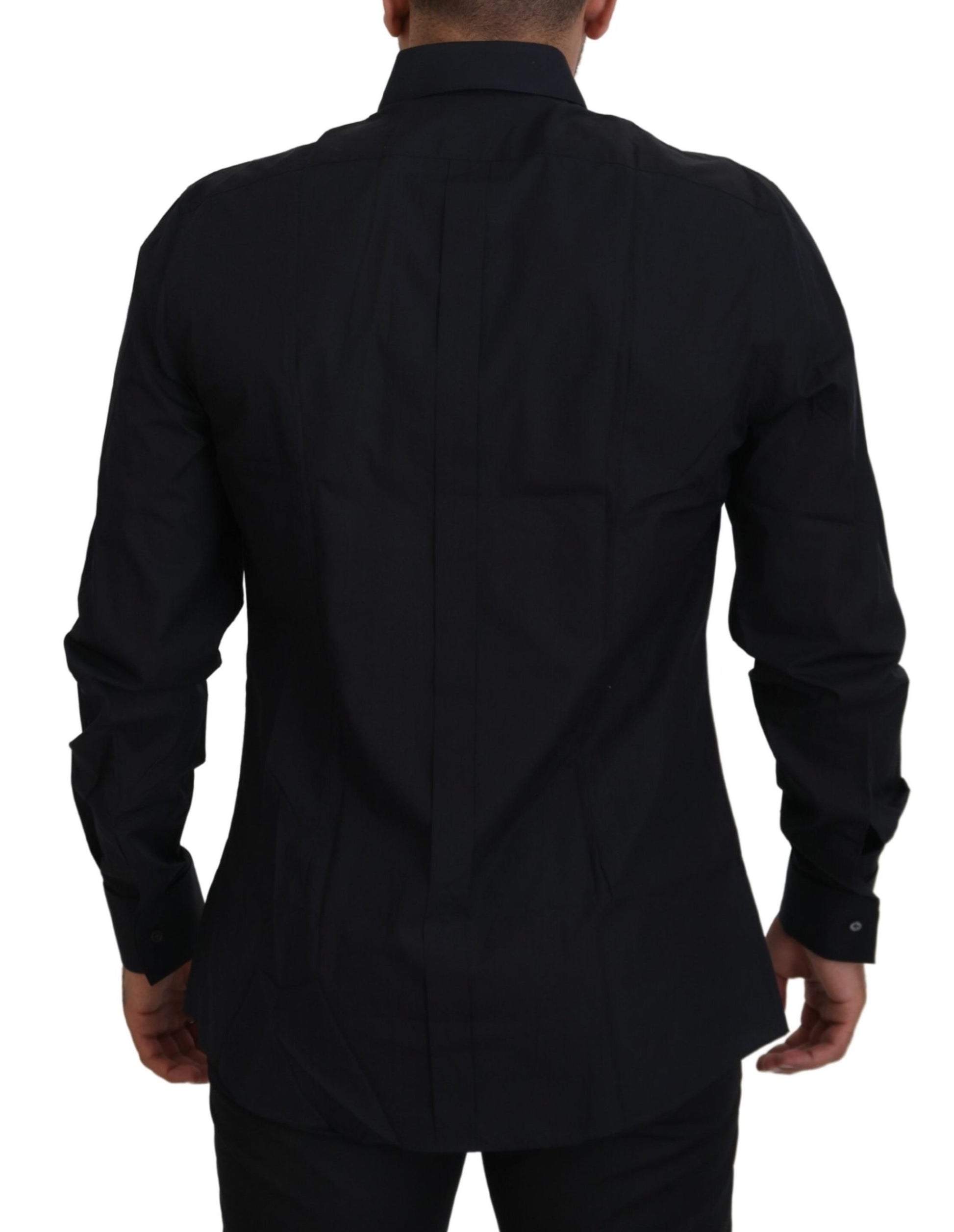A black dress shirt with gold accents, designed by Dolce & Gabbana. It is made of cotton and features a slim