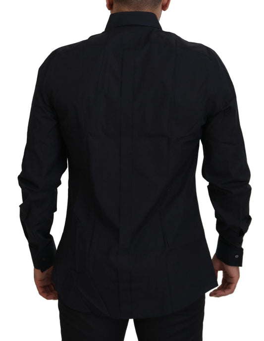 A black dress shirt with gold accents, designed by Dolce & Gabbana. It is made of cotton and features a slim