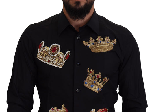 A black dress shirt with gold crowns embroidered on the chest and sleeves
