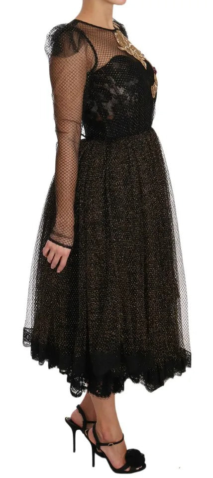 Long black dress with gold crystals and heart design, worn by a model