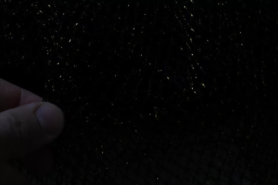 A black dress with gold crystals on it, featuring a heart design