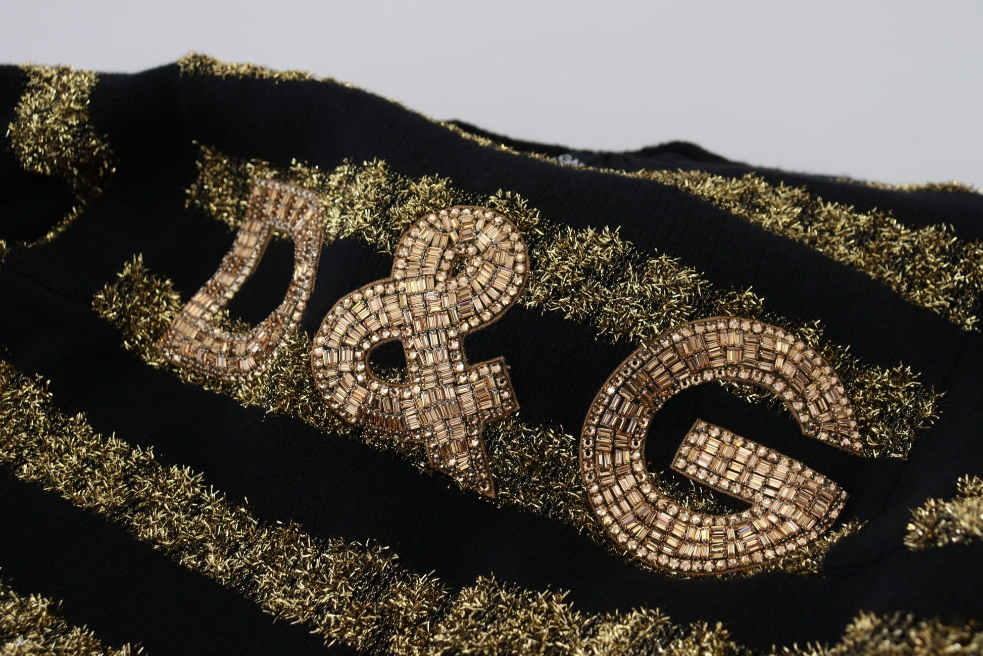 Black jacket with gold sequins spelling out D&G