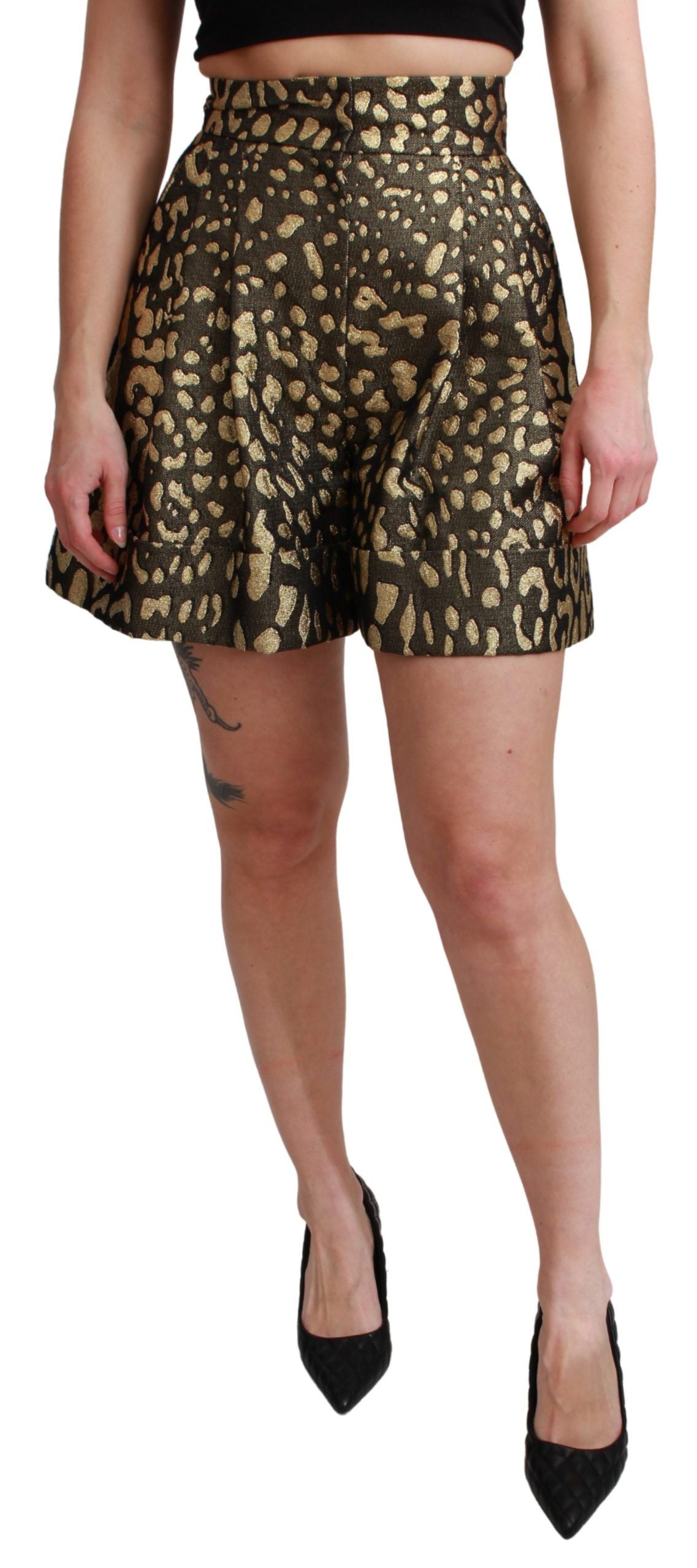 Woman wearing a black tank top and gold patterned skirt
