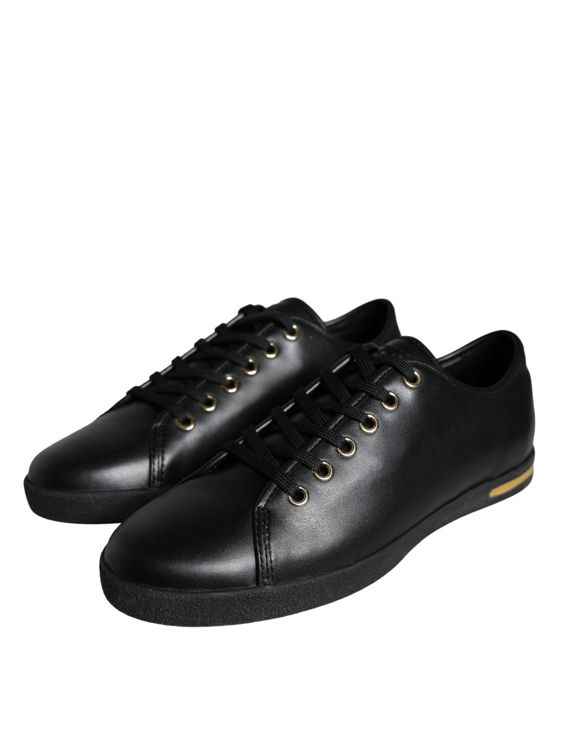 Pair of black shoes with gold laces and yellow stripe on side