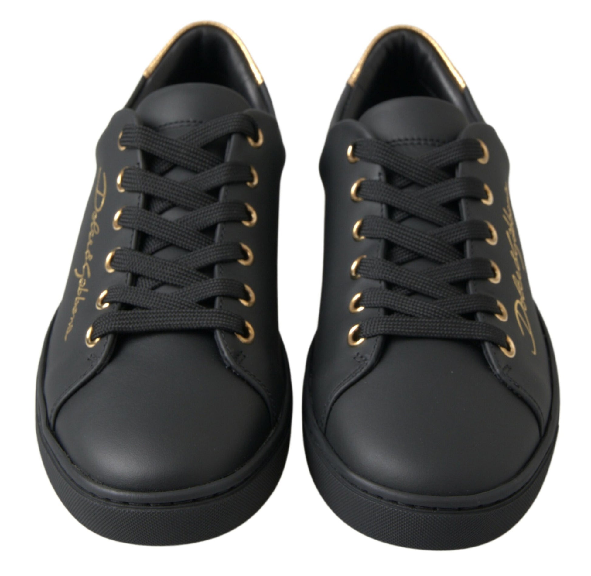 Pair of black sneakers with gold laces