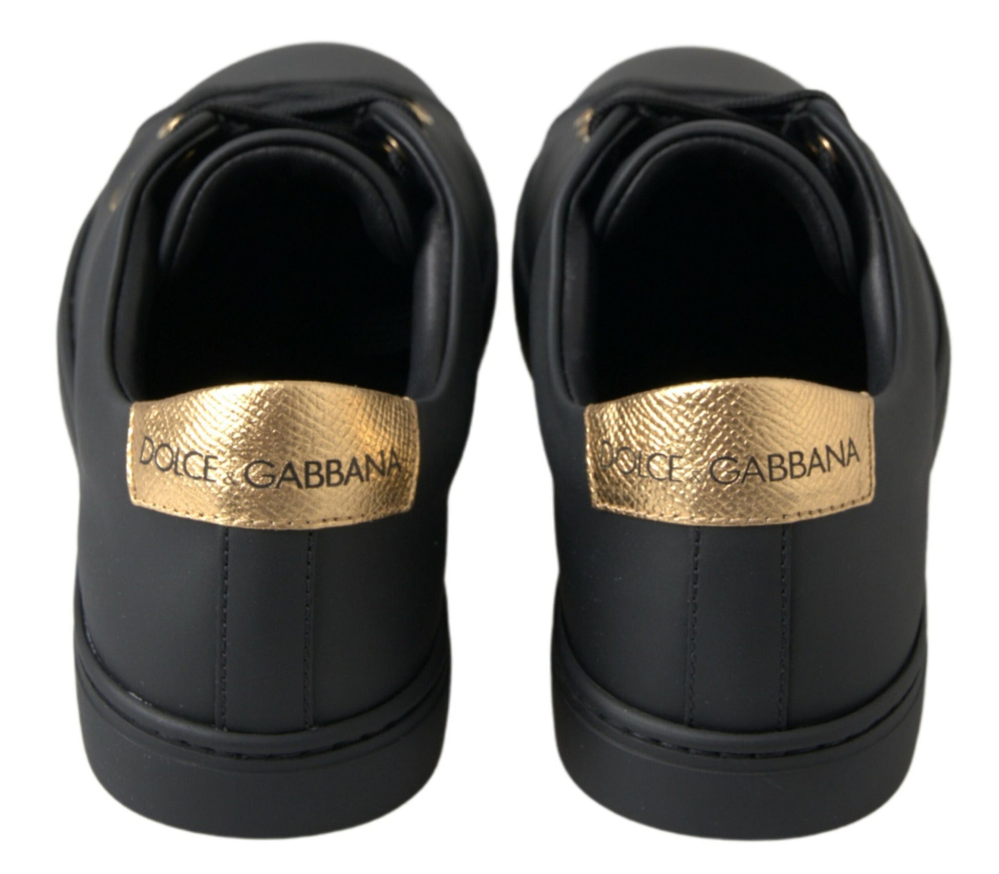 Pair of black sneakers with gold branding