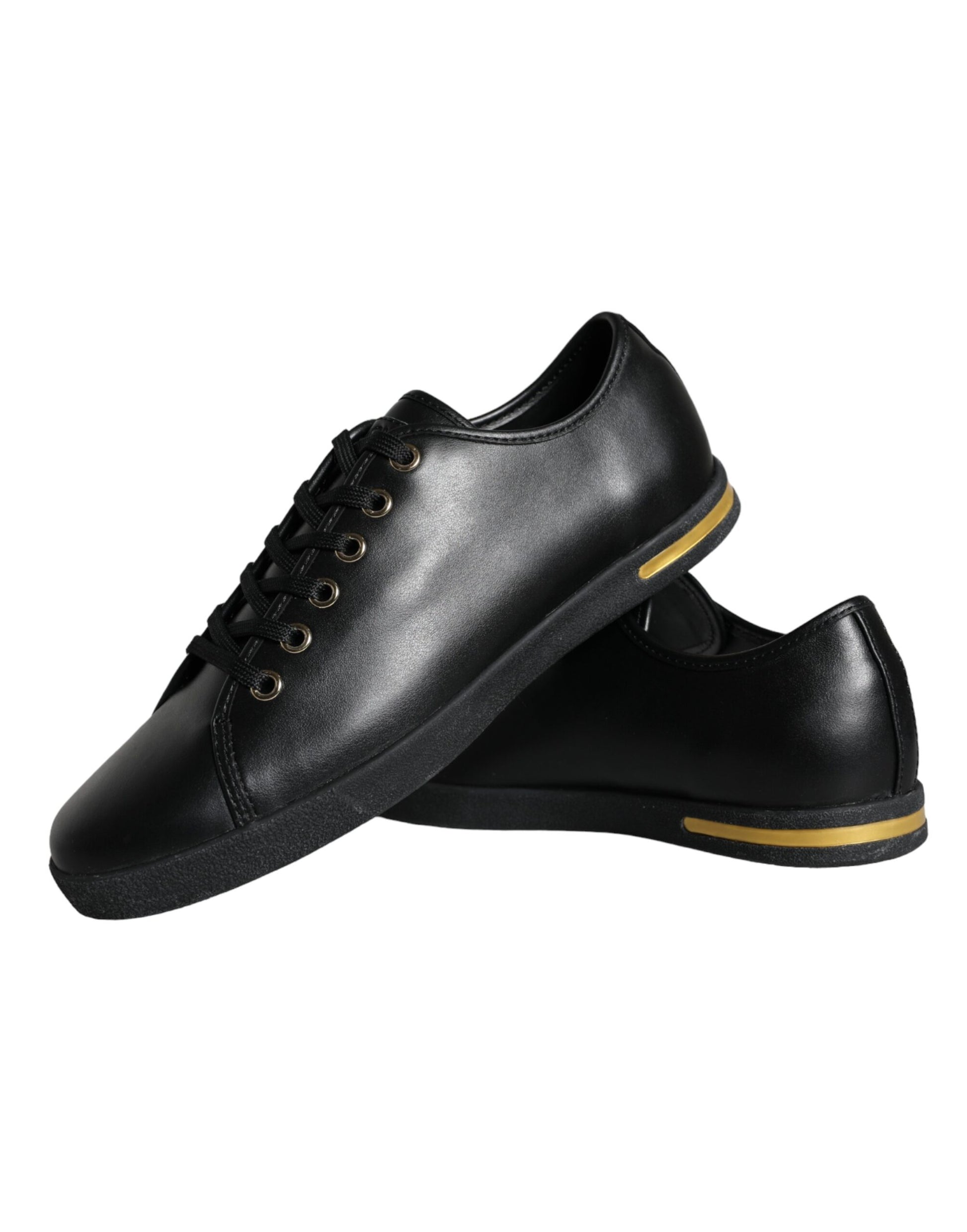 Pair of black shoes with yellow stripe on sides and laces