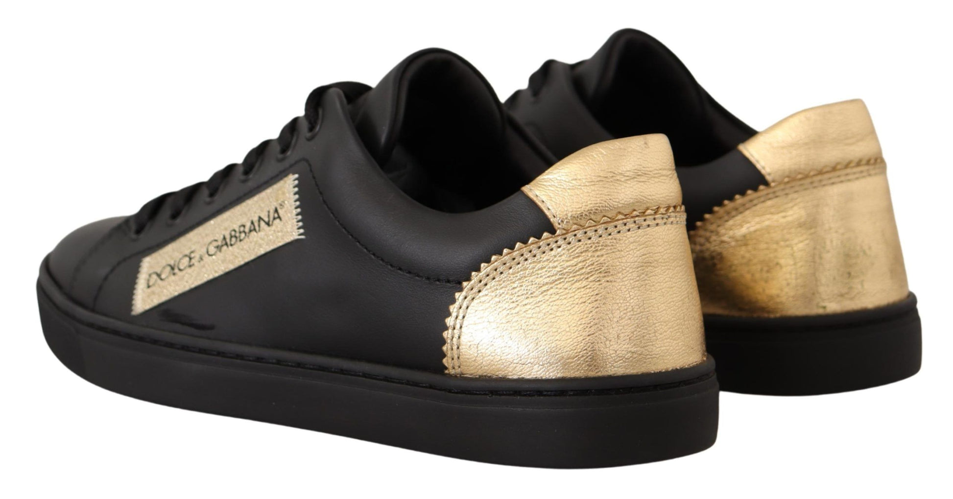 Pair of black sneakers with gold accents and a logo on the side
