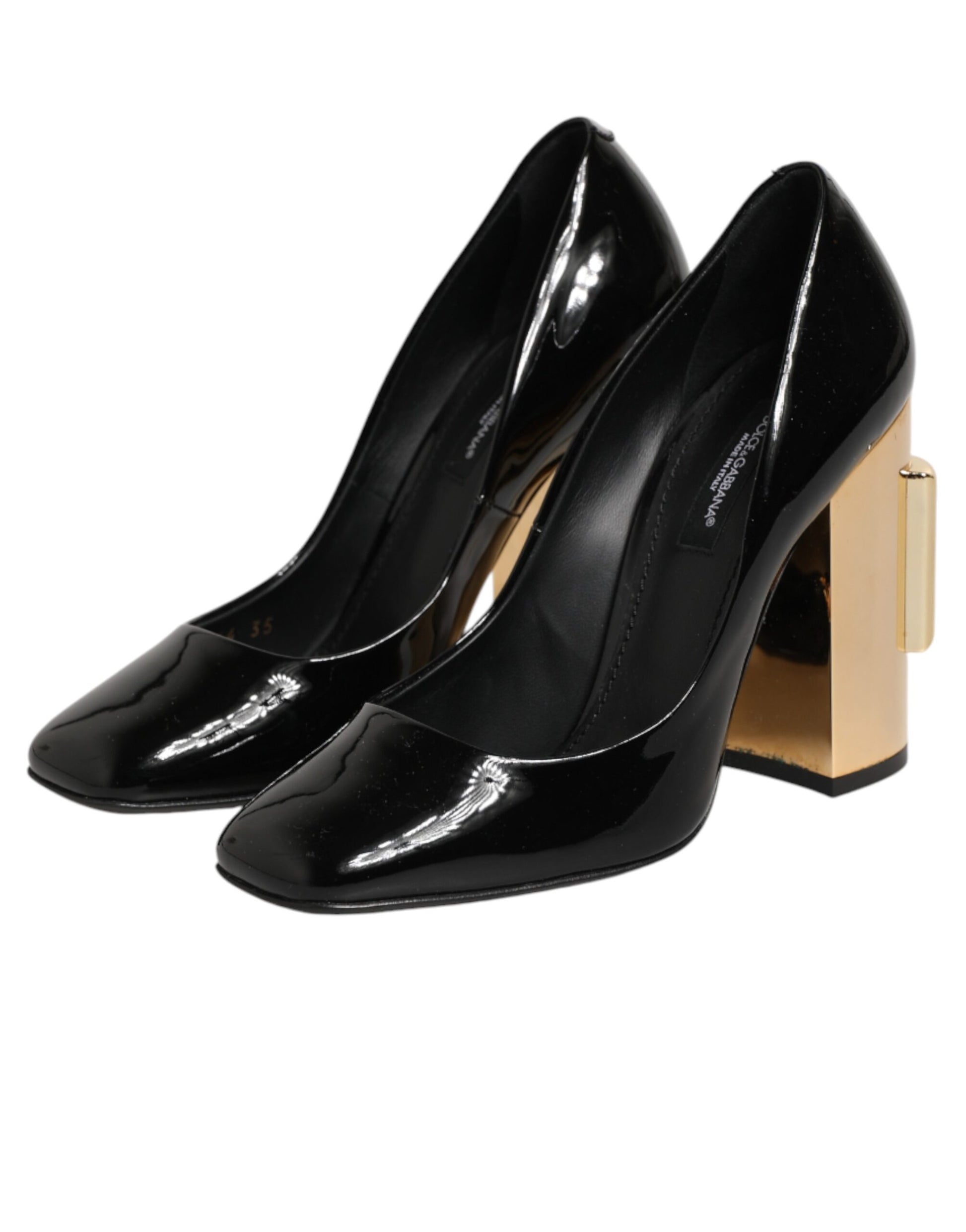 Pair of black high heel shoes with gold accents