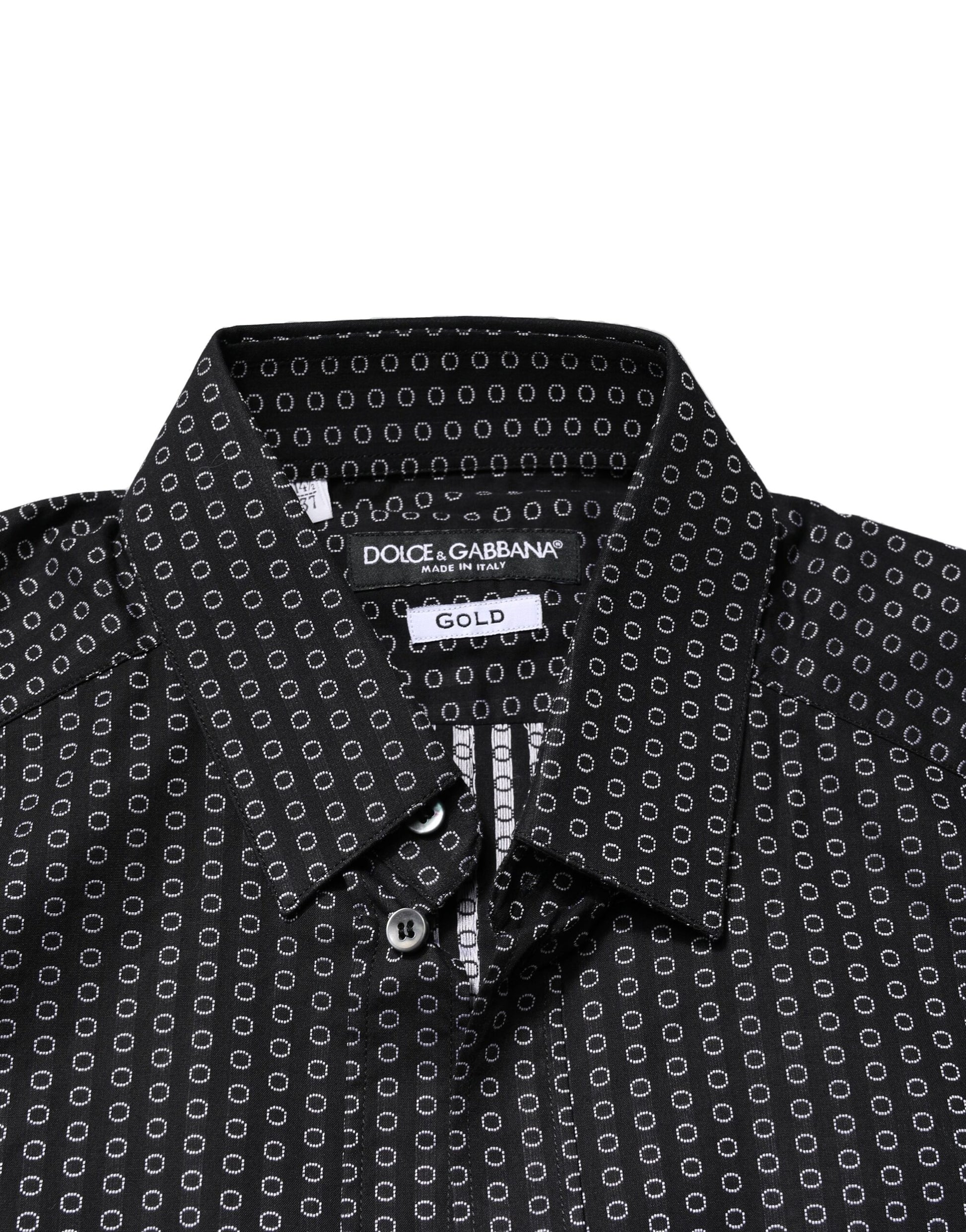 A black shirt with a gold pattern, featuring a collar and buttons