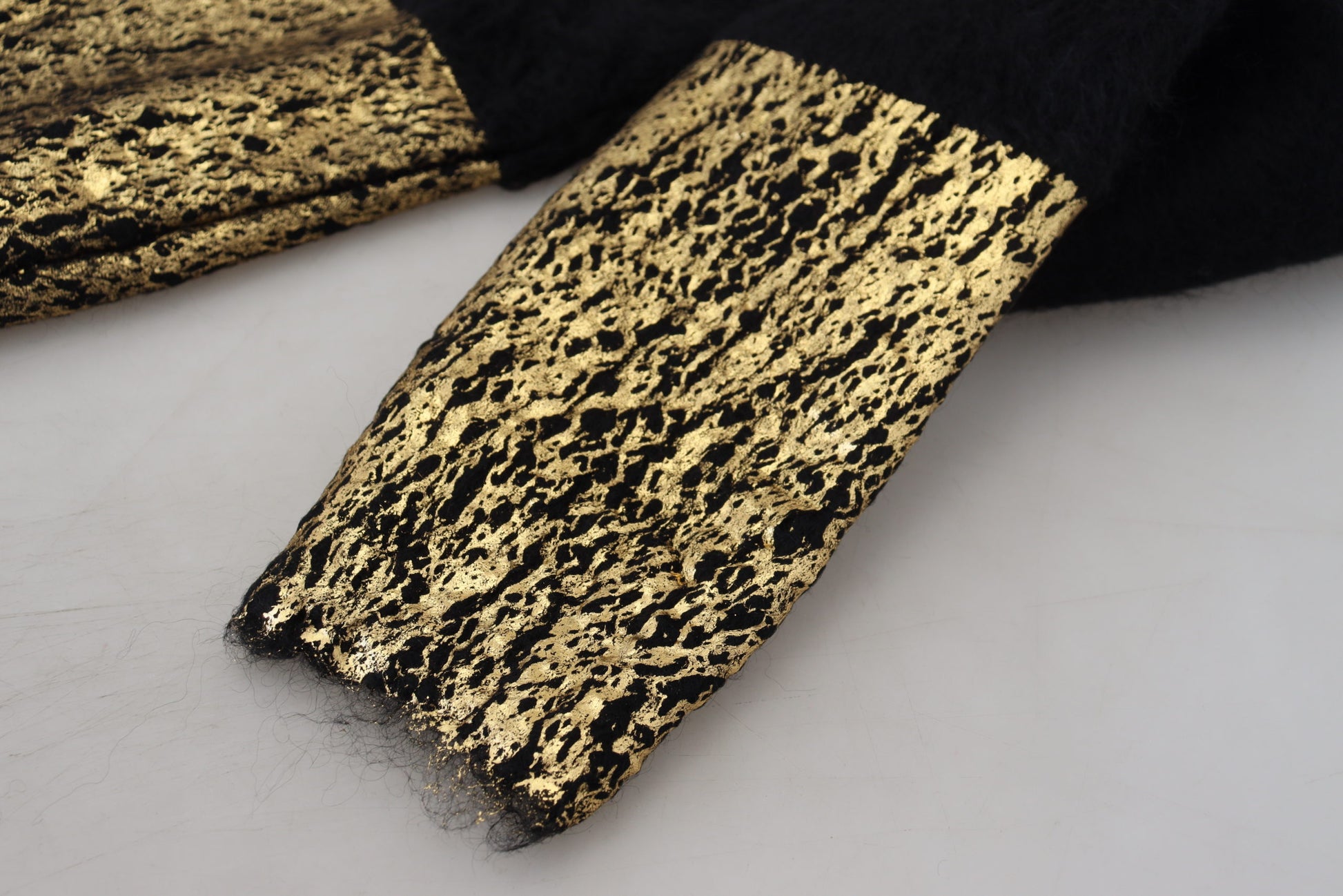 Gold foil fabric with black background