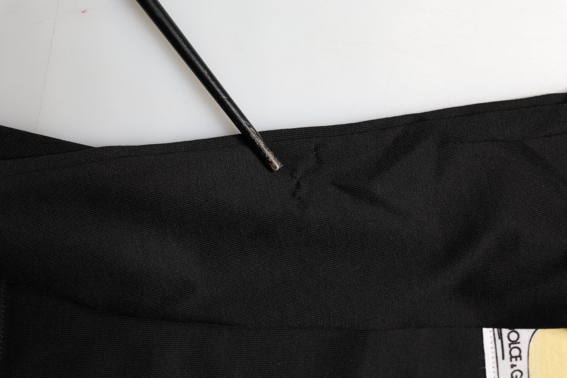 Black fabric with yellow logo on it