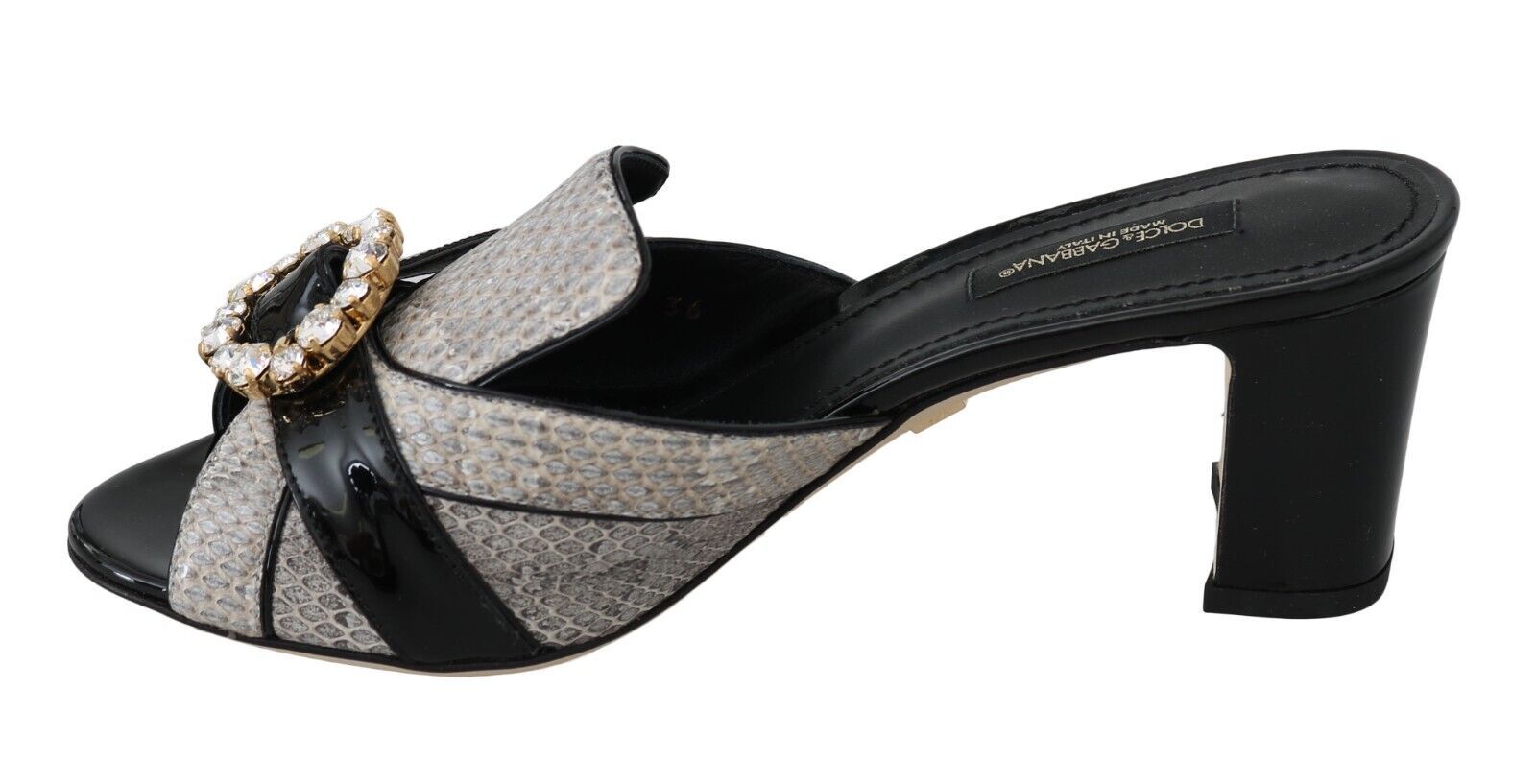 Black high heel shoe with a bow on top and a strap across the foot