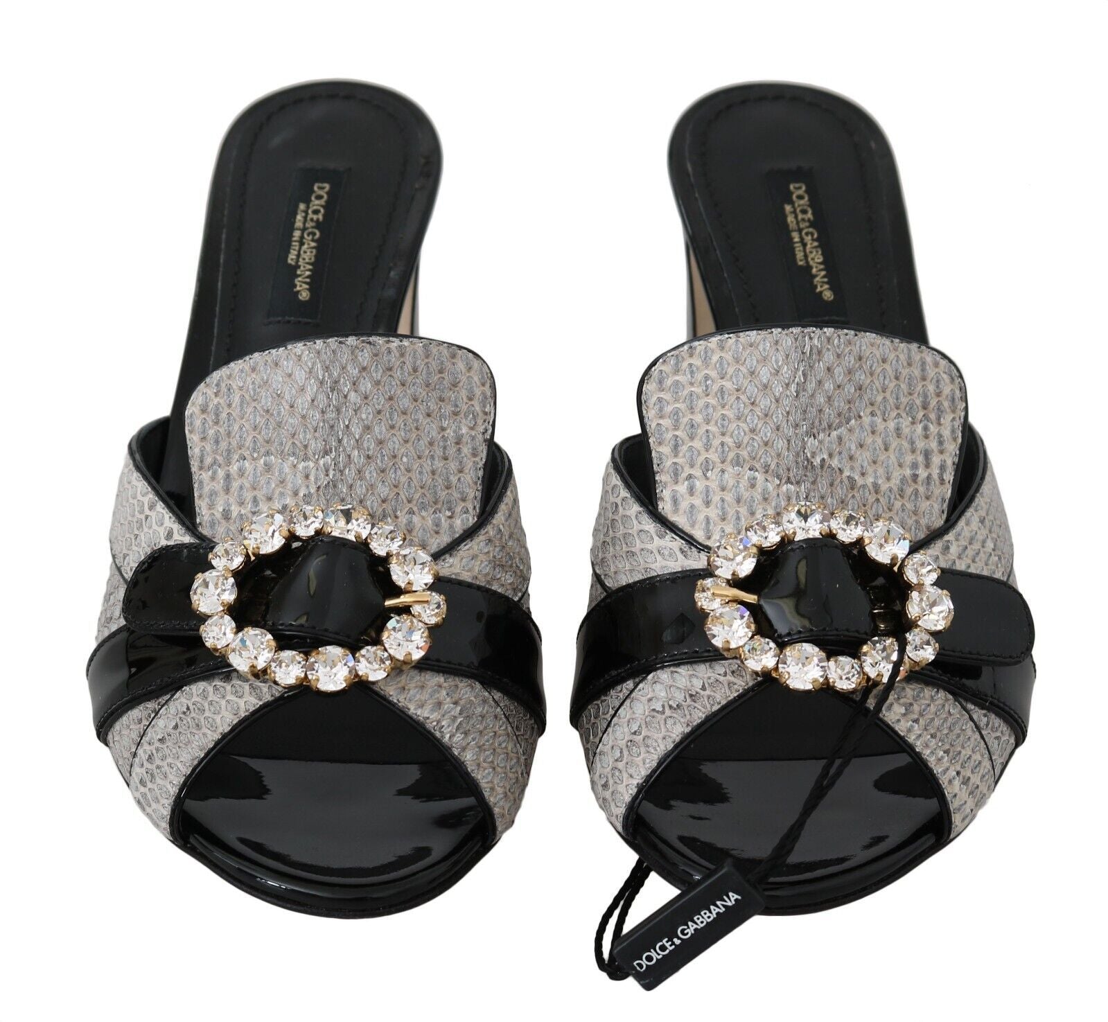 Pair of women's sandals with glittery straps and a round embellishment on each foot