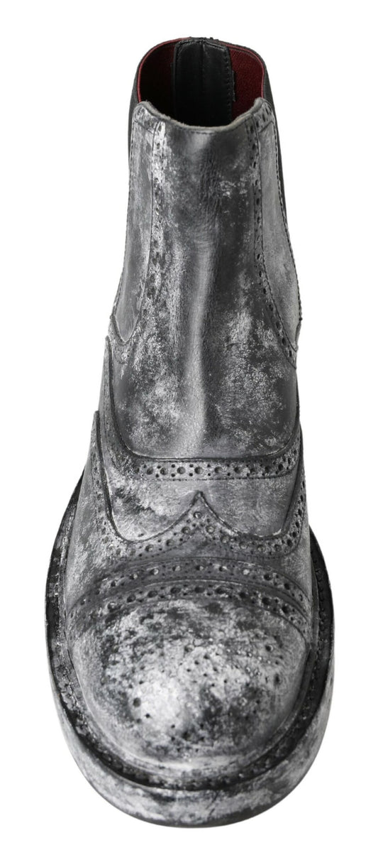 Silver and black boot with visible stitching and a round toe