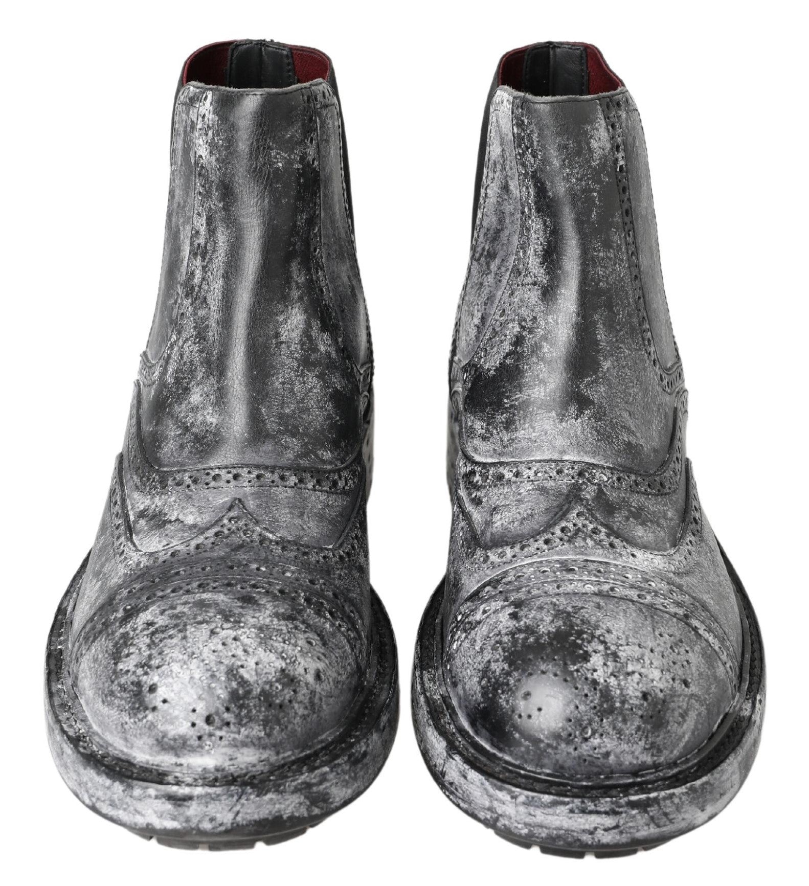 Pair of black boots with silver speckles and a red sole