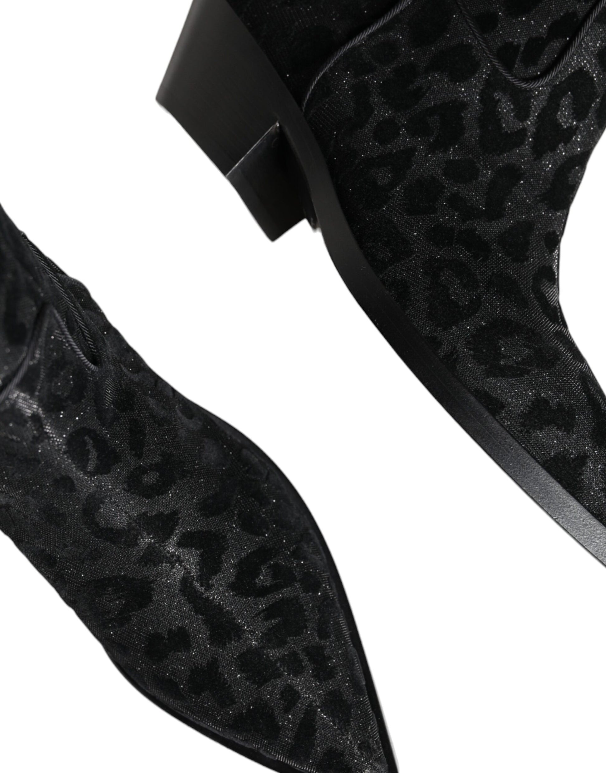 Pair of black suede boots with glittery pattern