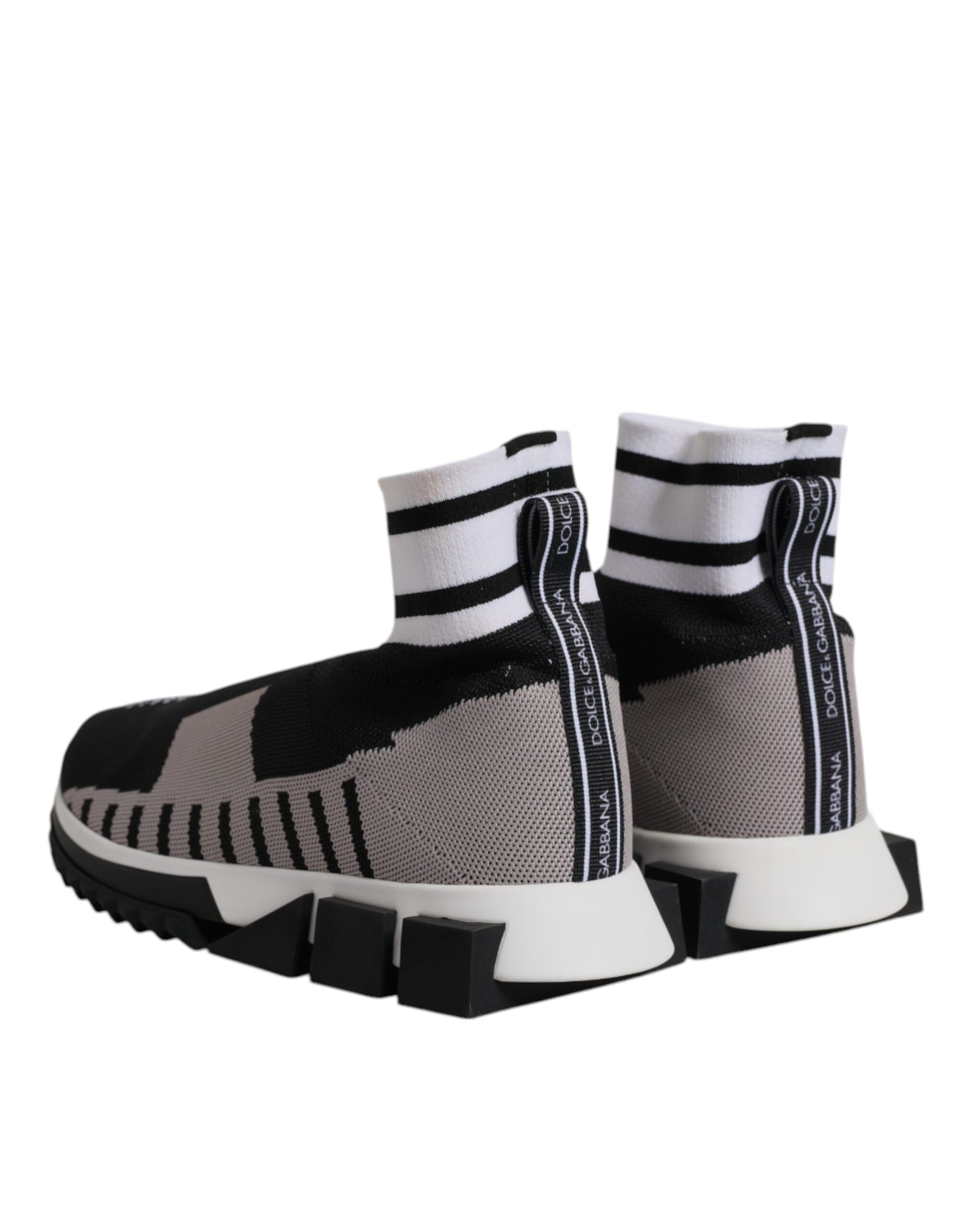 A pair of black, gray, and white women's sneakers with a knit pattern