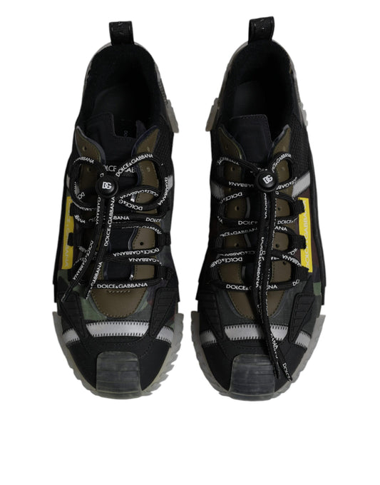 Pair of black sneakers with white laces and yellow accents