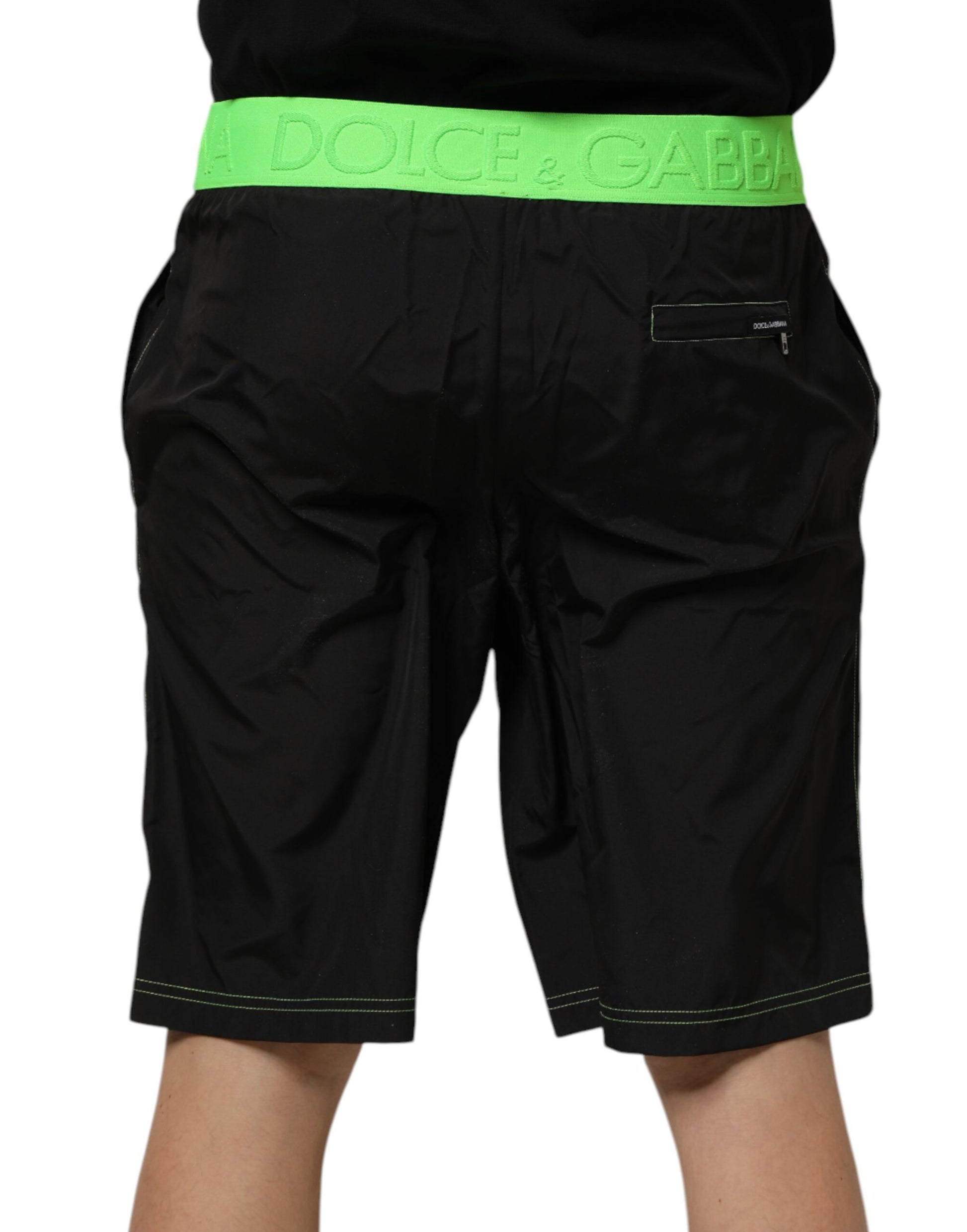 Black shorts with green trim and white logo