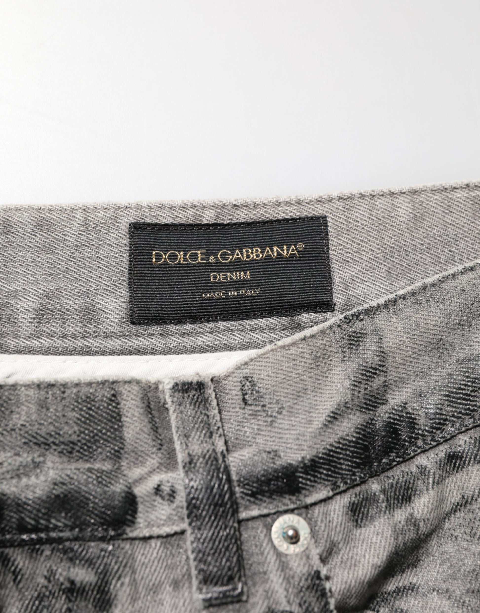 Pair of light grey denim jeans with a black label on the waistband