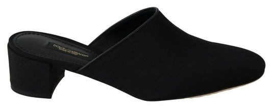 Black flat shoes with a strap over the foot and a heel