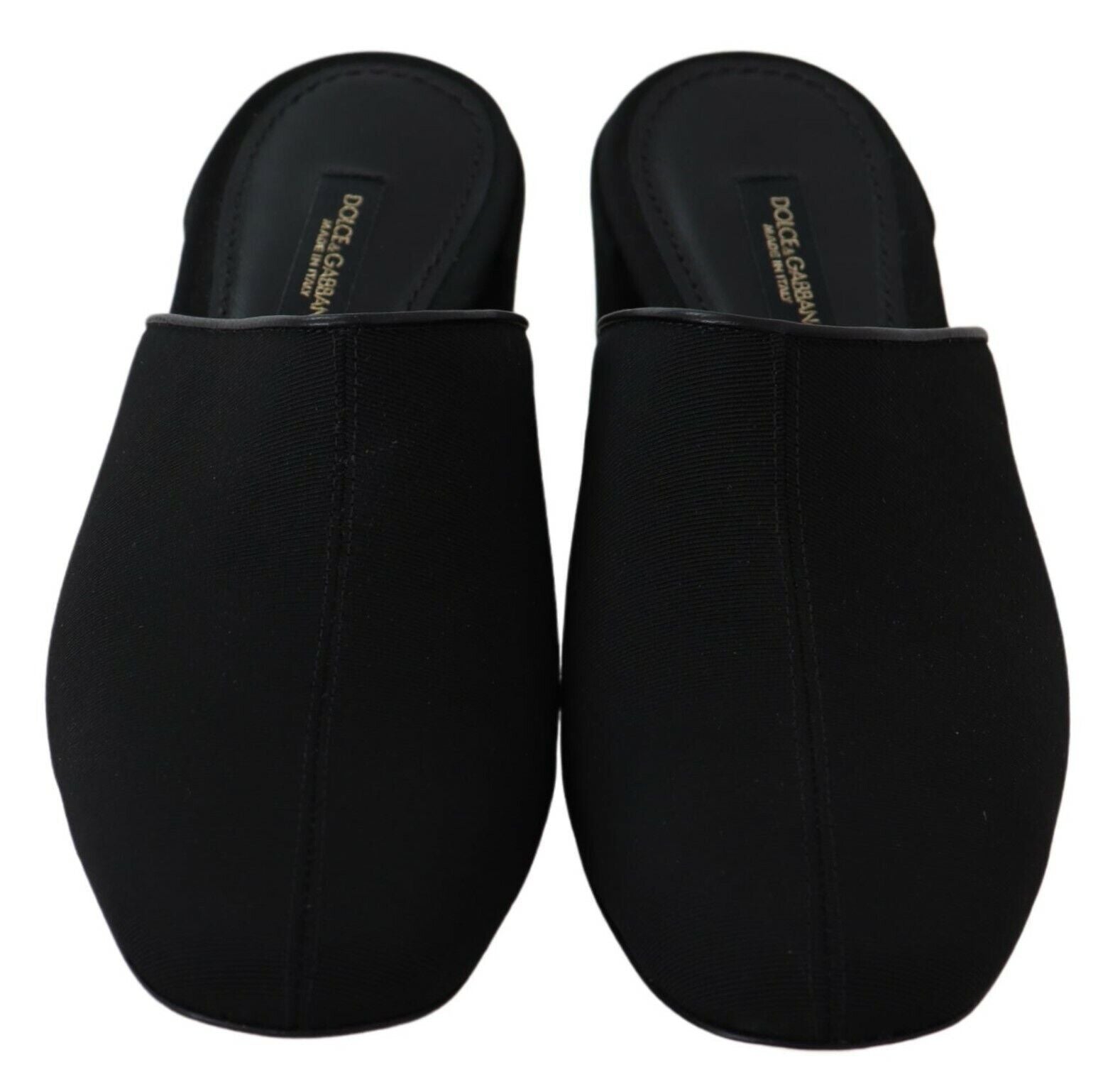 Pair of black slippers with elastic straps and a small heel