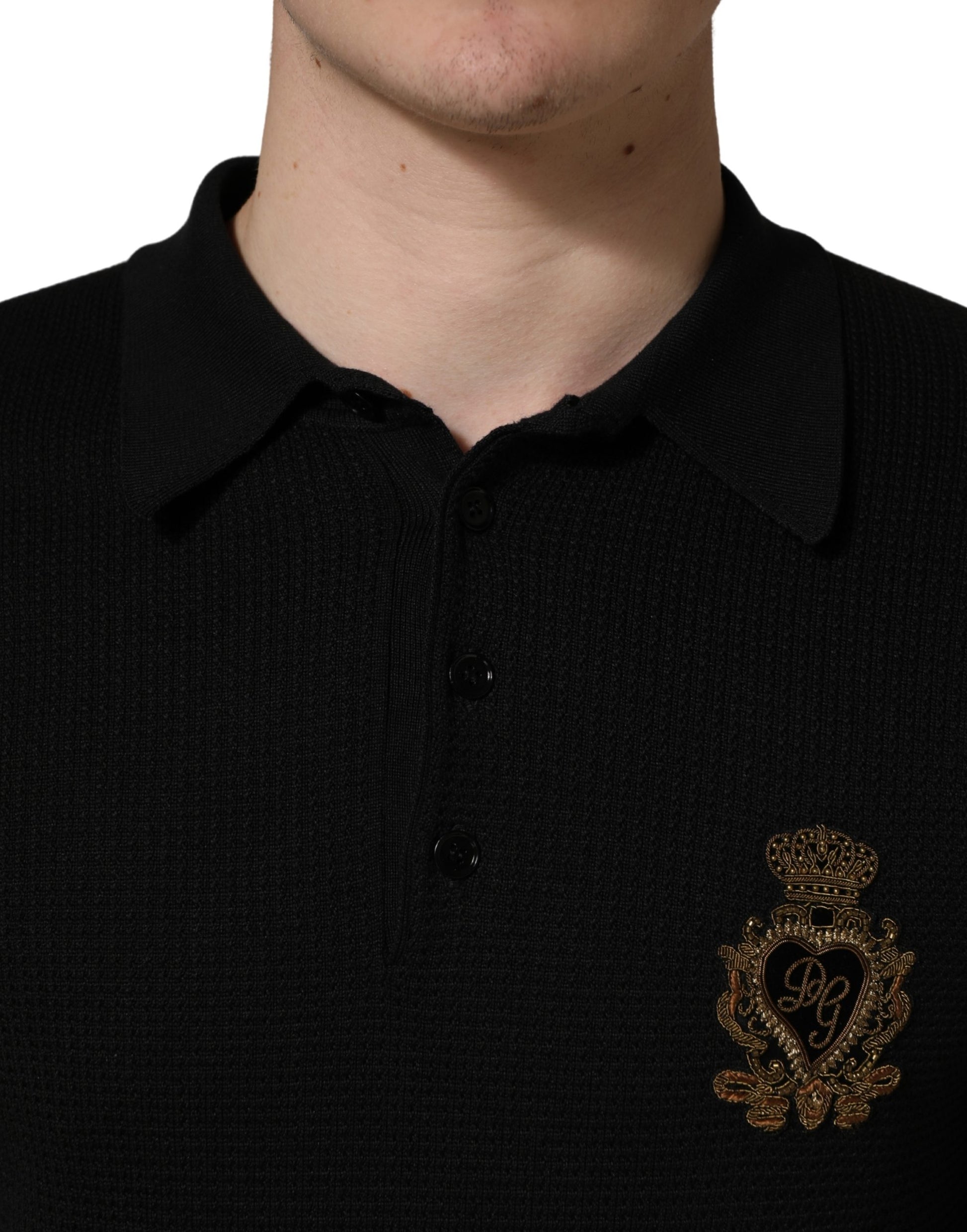 Black polo shirt with gold emblem on left chest