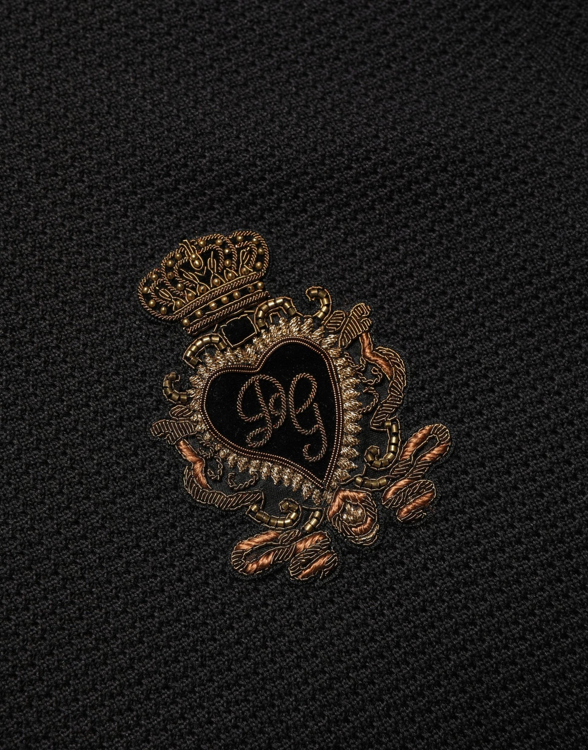 Gold embroidered heart on black fabric