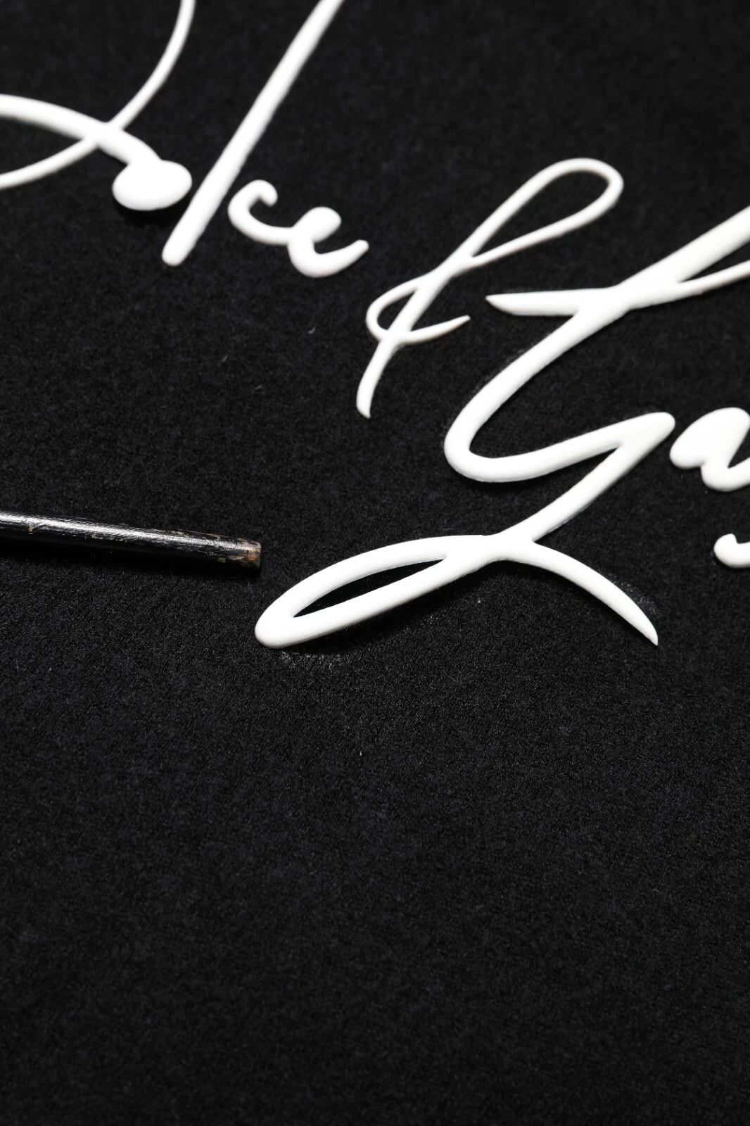 Small metal nail on black surface
