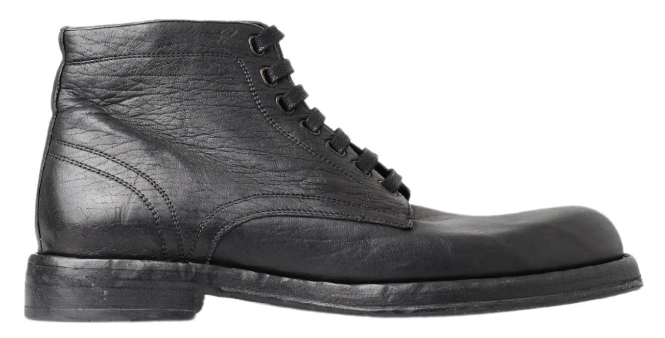 Black leather lace-up boots with visible stitching and a round toe