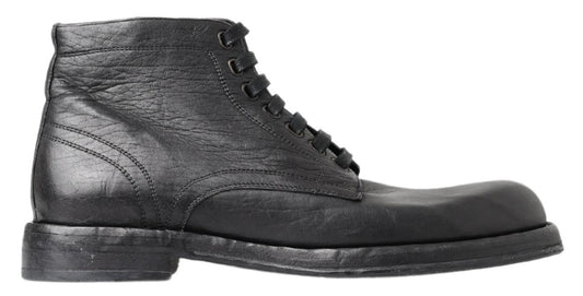 Black leather lace-up boots with visible stitching and a round toe