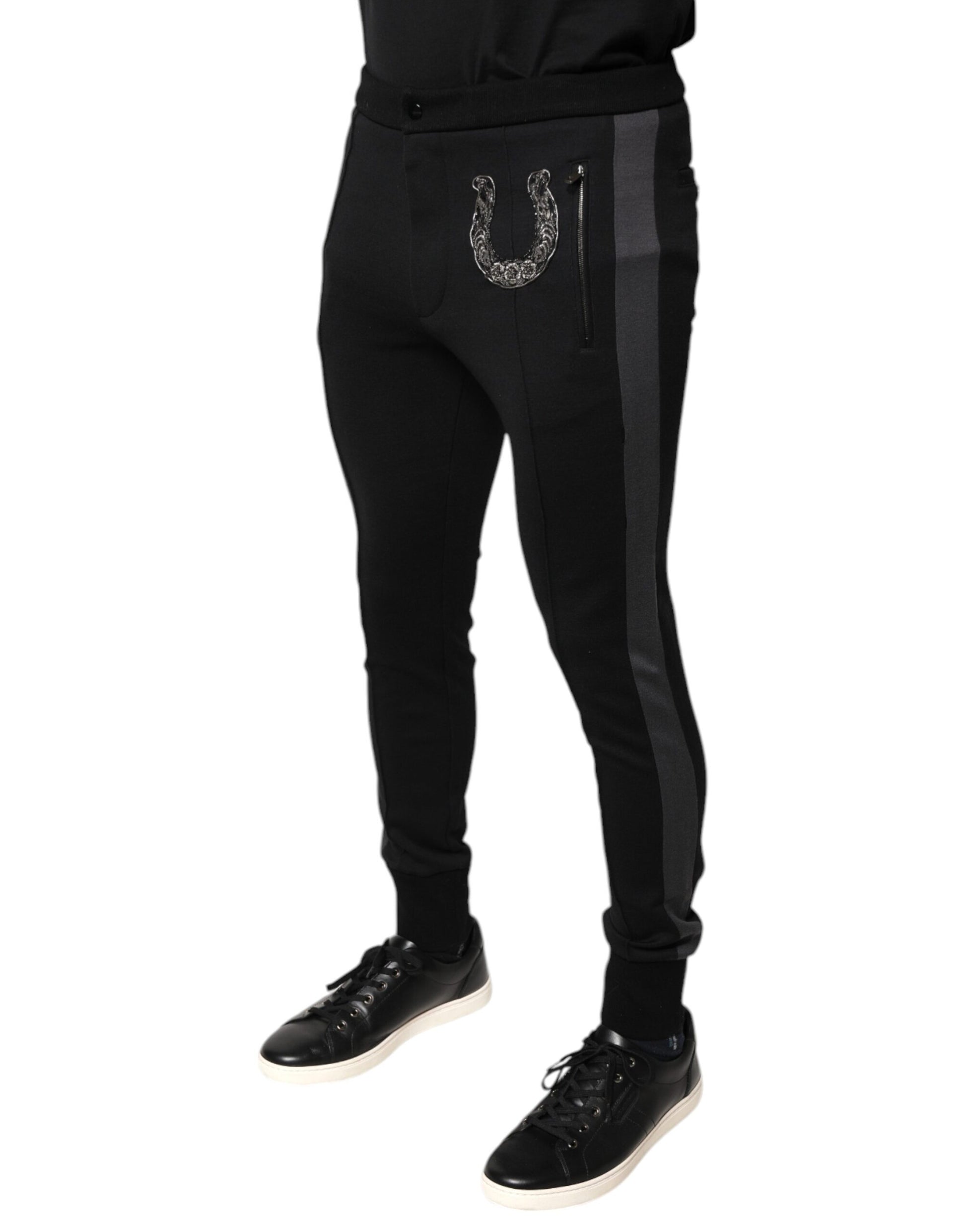 Black track pants with a silver buckle on the side