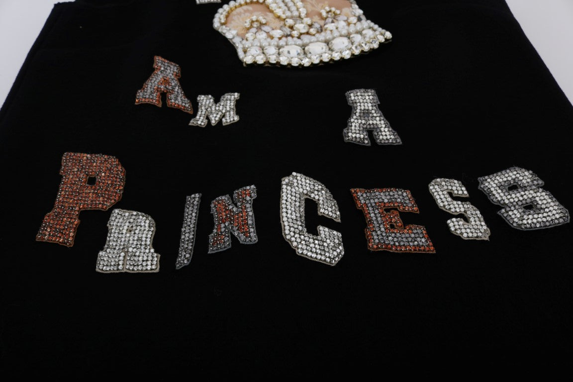 Shiny sequins spell out princess on black background