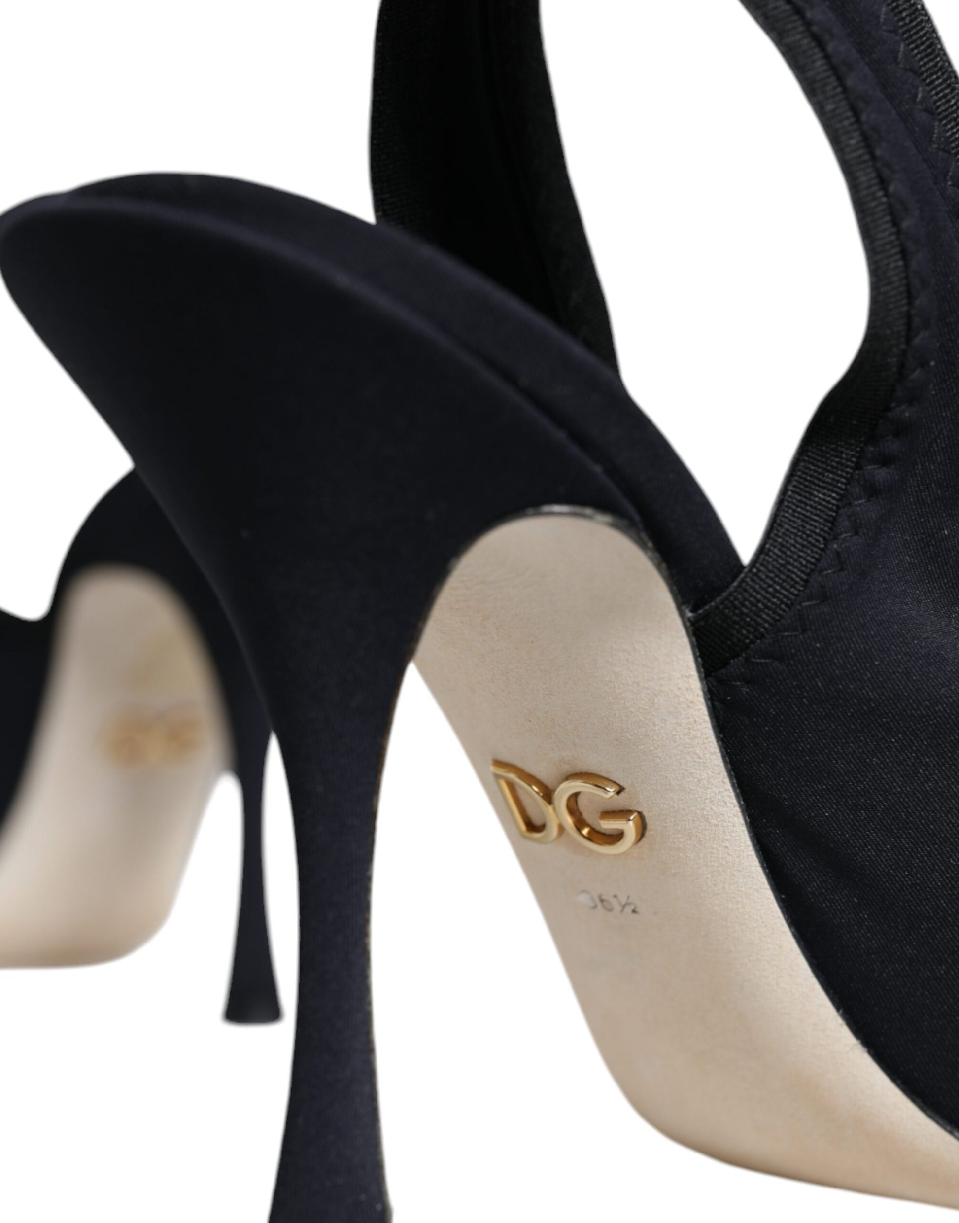 Pair of black high heel shoes with tan soles
