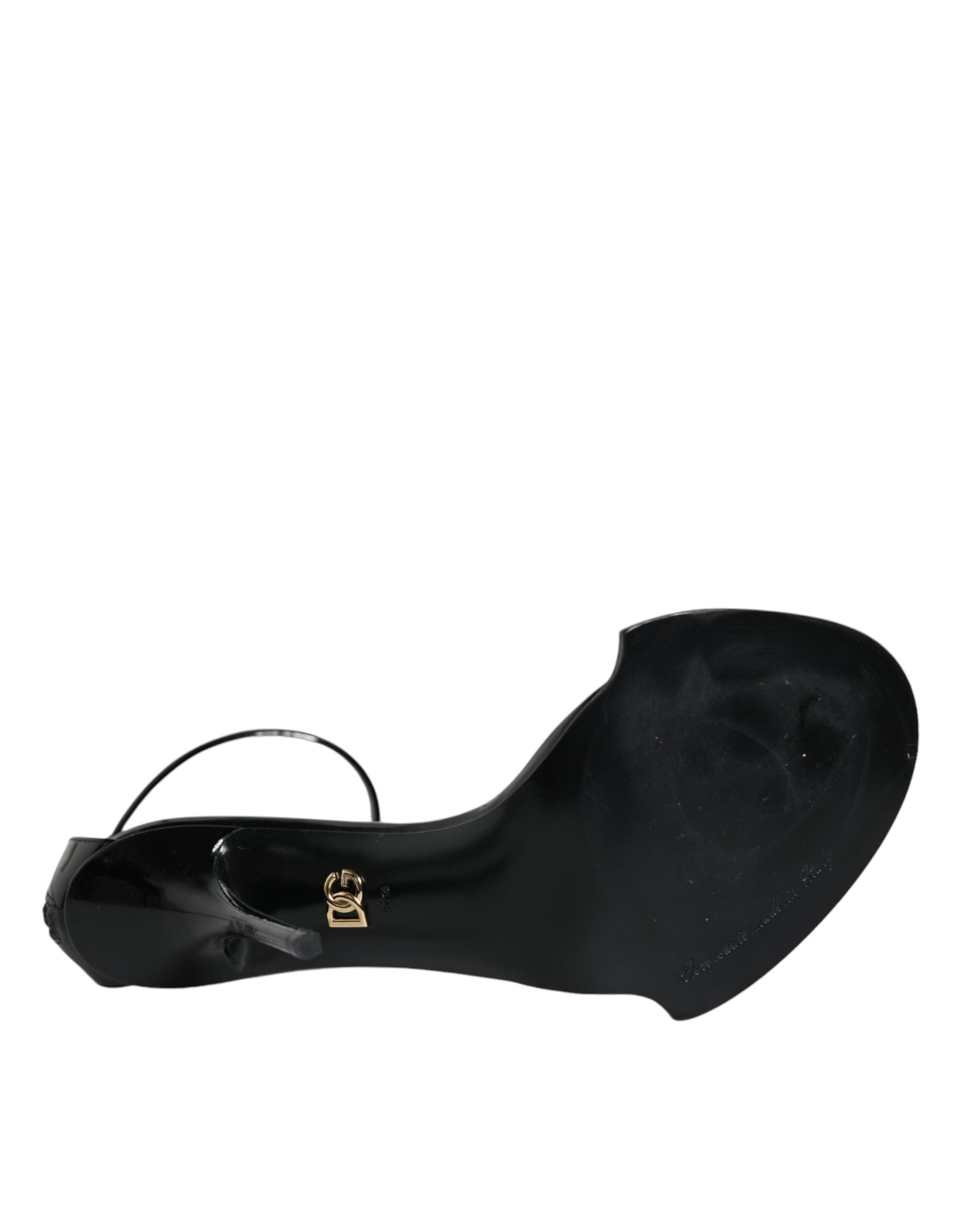 Black high heel shoe with strap over toe
