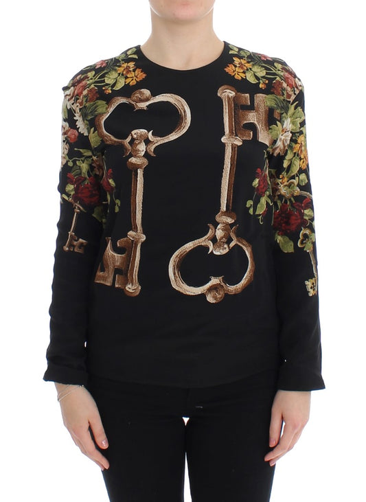Black sweater with floral pattern and keys embroidered on front