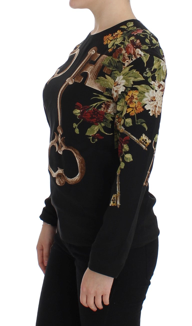 Woman wearing black sweater with floral embroidery on front