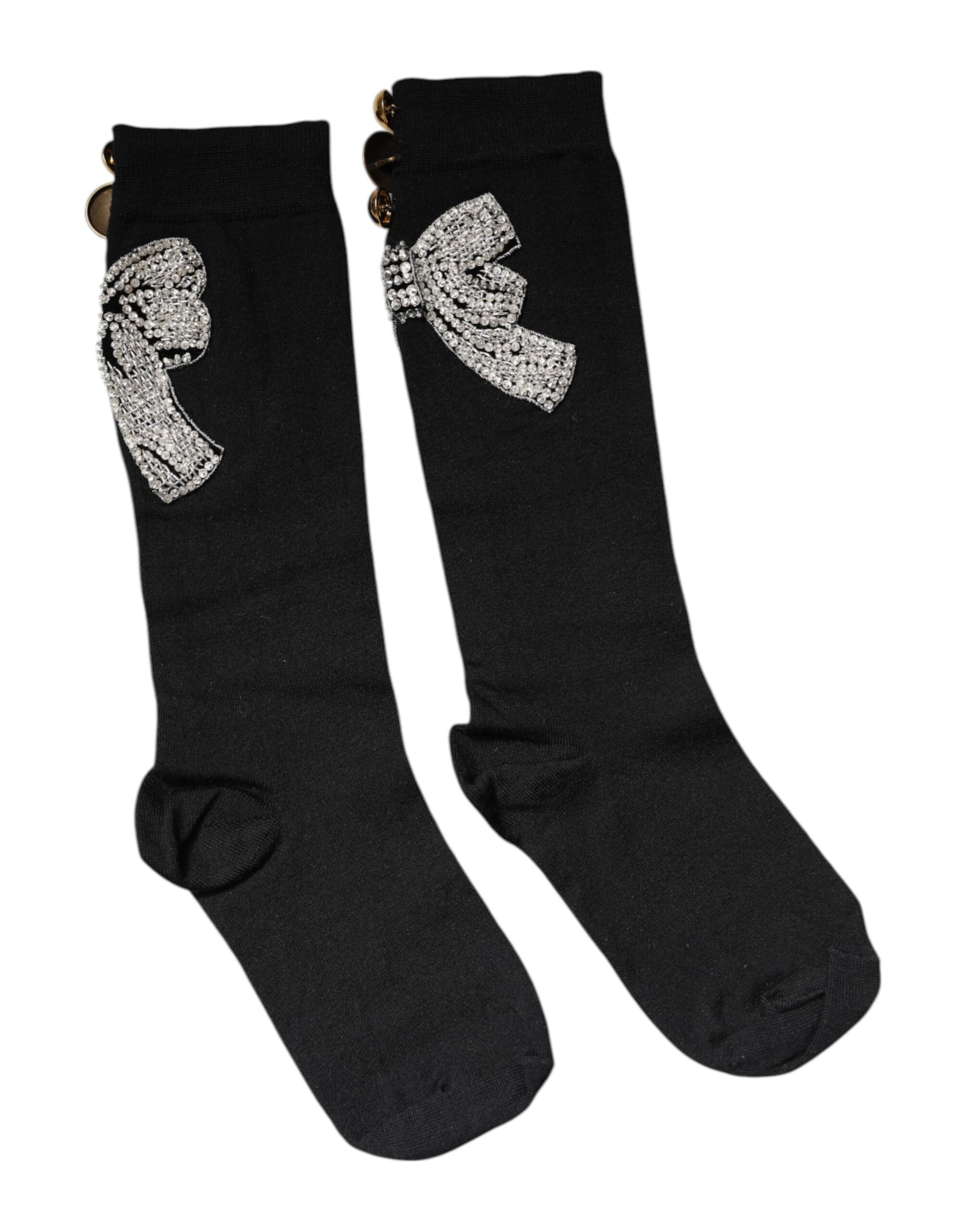 Pair of black socks with a bow design on top