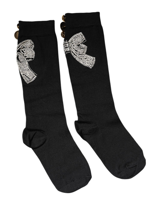 Pair of black socks with a bow design on top