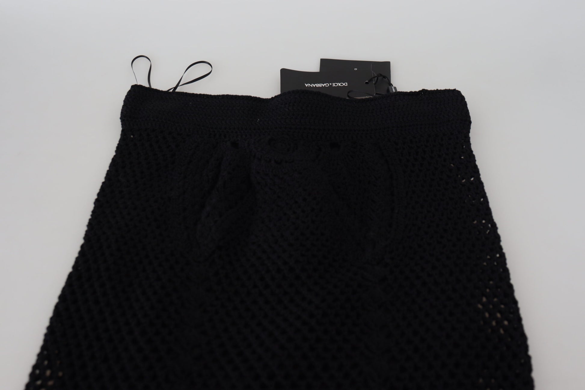 Black lace shorts on a white surface